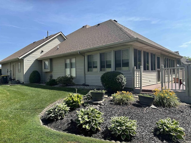 6420 Langley Ct, Fort Wayne, IN 46815 - view of side of home featuring a shingled roof, a yard, and a deck
