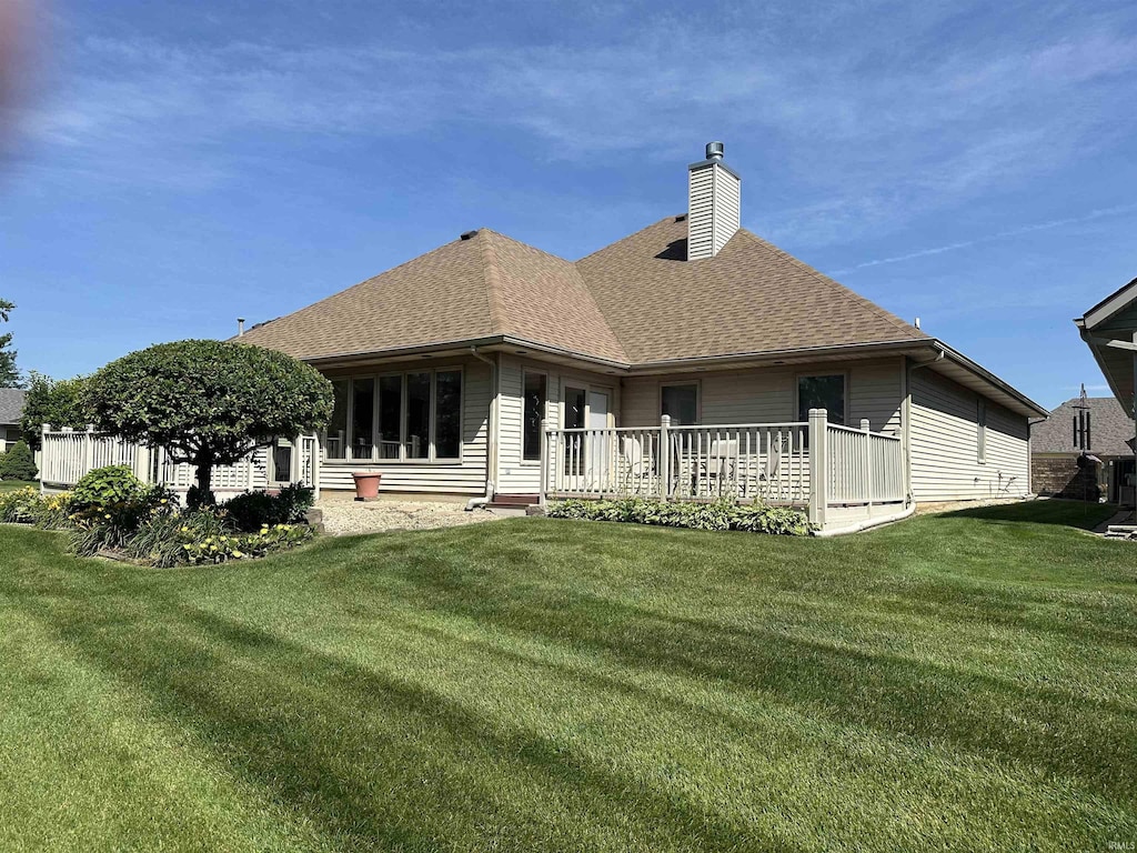6420 Langley Ct, Fort Wayne, IN 46815 - rear view of property with a chimney, roof with shingles, a yard, and a wooden deck