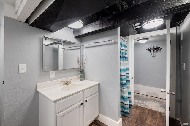 919 S 18th St, Lafayette, IN 47905 - bathroom with wood finished floors, vanity, curtained shower, and a textured wall