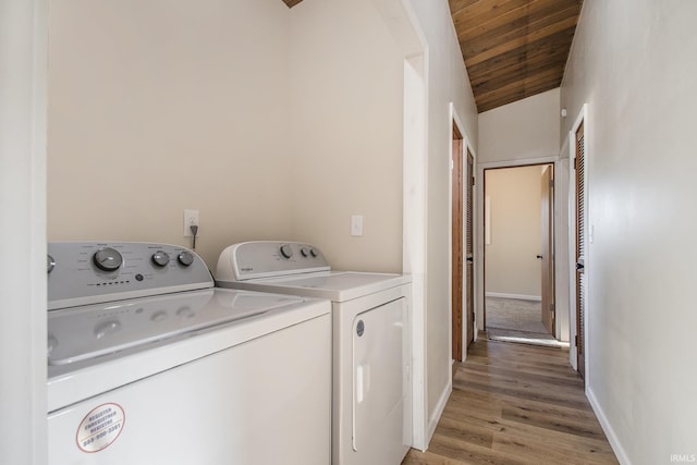 56435 Eastlea Dr, South Bend, IN 46619 - washroom with washing machine and dryer, wood ceiling, and light wood-style floors
