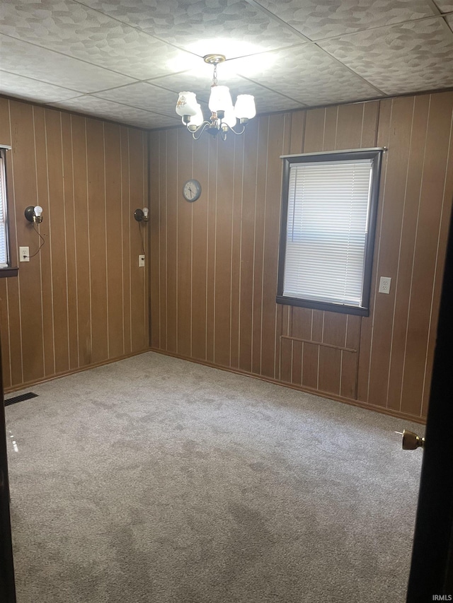 517 S Main St, Jonesboro, IN 46938 - unfurnished room featuring carpet, a chandelier, and wood walls