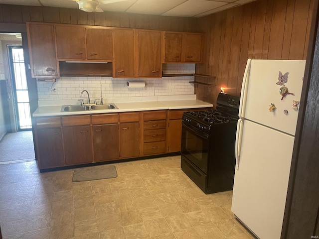 517 S Main St, Jonesboro, IN 46938 - kitchen with black gas stove, freestanding refrigerator, open shelves, light countertops, and wood walls