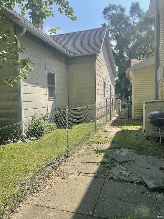 517 S Main St, Jonesboro, IN 46938 - view of side of property with a shingled roof and a chimney
