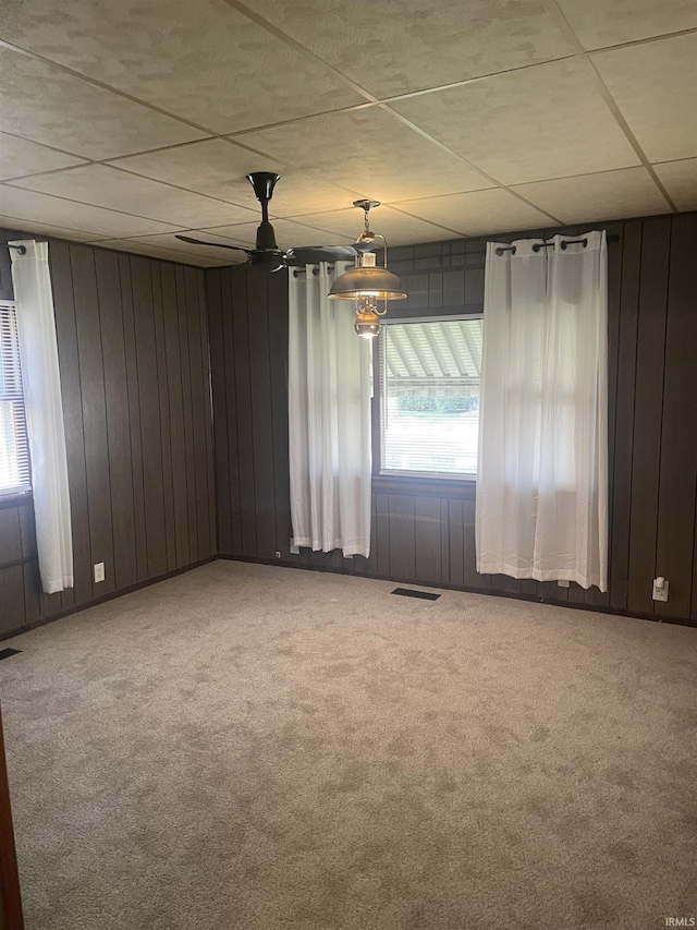 517 S Main St, Jonesboro, IN 46938 - carpeted empty room featuring wood walls and a ceiling fan