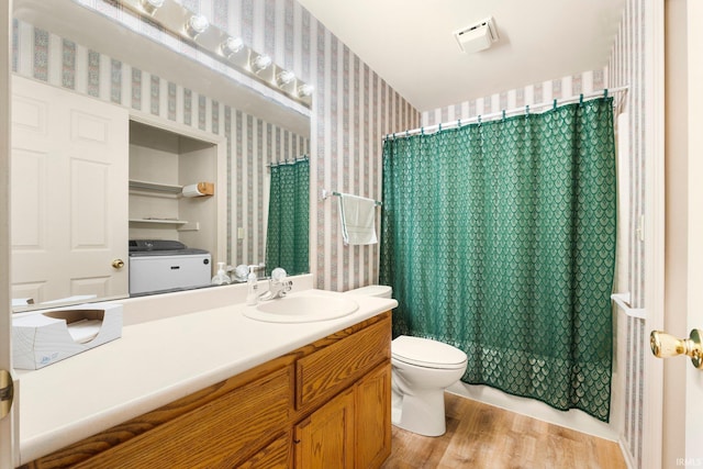 1408 Duesenberg Dr, Auburn, IN 46706 - bathroom featuring wallpapered walls, washer / dryer, vanity, wood finished floors, and curtained shower