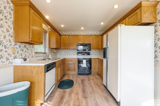 1408 Duesenberg Dr, Auburn, IN 46706 - kitchen with white appliances, wallpapered walls, light wood-style flooring, light countertops, and recessed lighting
