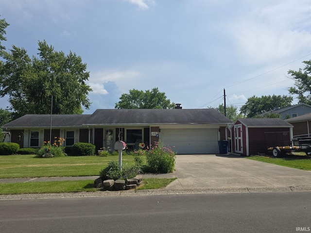 1723 W Timberview Dr, Marion, IN 46952 - ranch-style house with a front yard, a garage, concrete driveway, and a storage shed