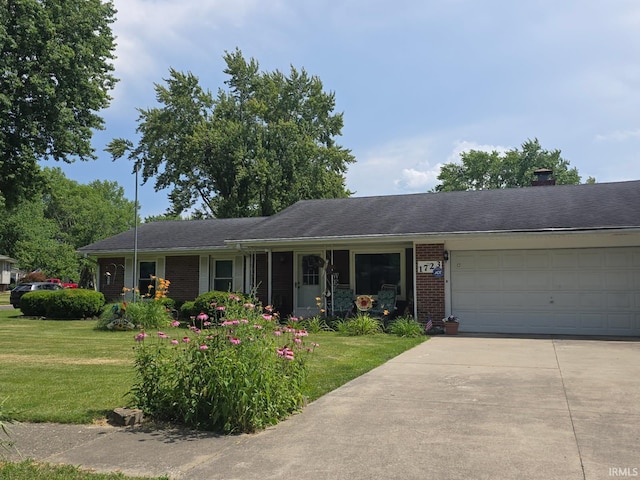 1723 W Timberview Dr, Marion, IN 46952 - ranch-style house with brick siding, a front yard, concrete driveway, and an attached garage