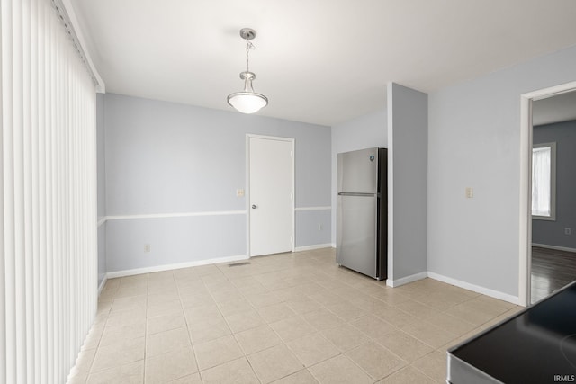 415 Grapevine Ln, Fort Wayne, IN 46825 - unfurnished dining area featuring light tile patterned flooring and baseboards