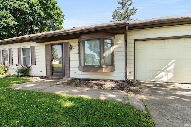 415 Grapevine Ln, Fort Wayne, IN 46825 - view of front facade featuring a garage and driveway