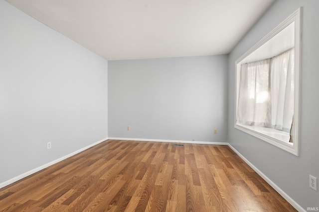 415 Grapevine Ln, Fort Wayne, IN 46825 - empty room featuring wood finished floors and baseboards
