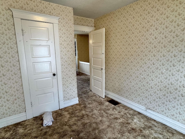 325 W Linden Ave, Logansport, IN 46947 - carpeted empty room with wallpapered walls