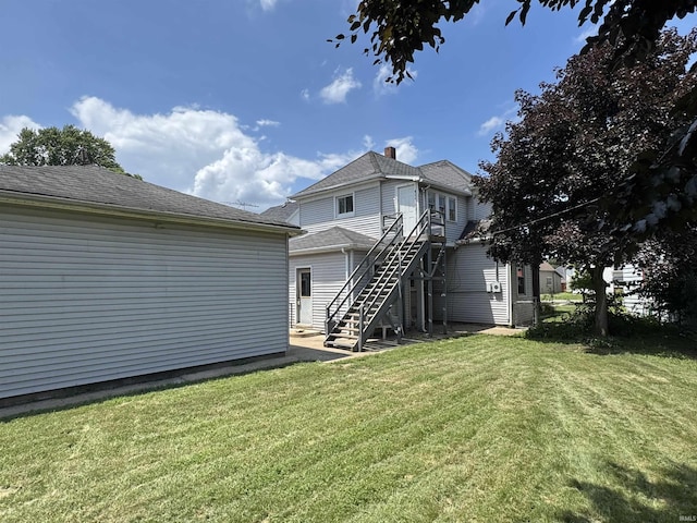 325 W Linden Ave, Logansport, IN 46947 - rear view of property featuring stairs and a lawn