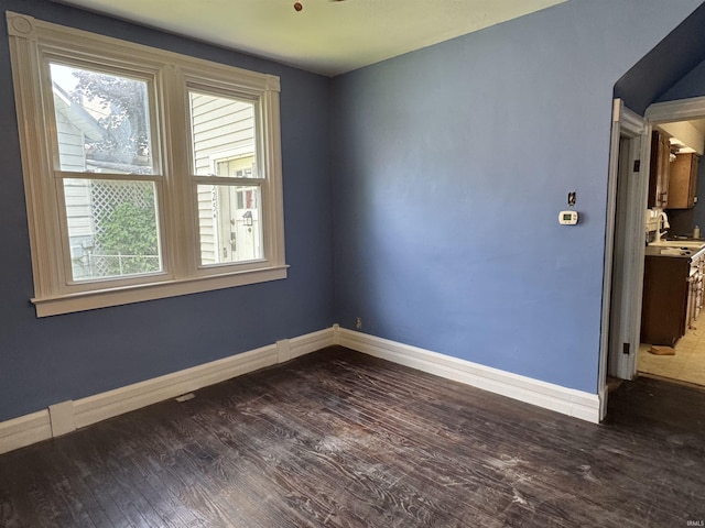 325 W Linden Ave, Logansport, IN 46947 - empty room featuring healthy amount of natural light and dark wood finished floors