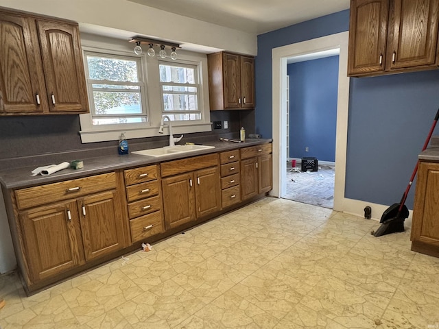 325 W Linden Ave, Logansport, IN 46947 - kitchen with dark countertops and brown cabinetry