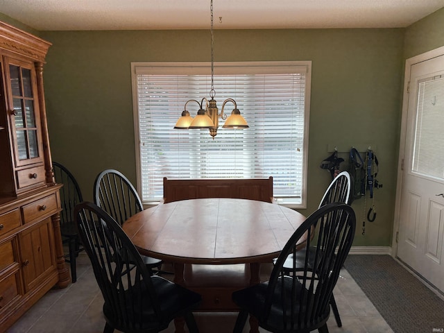 9825 Tamar Trl, Fort Wayne, IN 46825 - tiled dining room featuring a chandelier