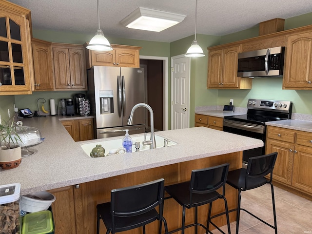 9825 Tamar Trl, Fort Wayne, IN 46825 - kitchen featuring appliances with stainless steel finishes, a peninsula, glass insert cabinets, a breakfast bar area, and light countertops
