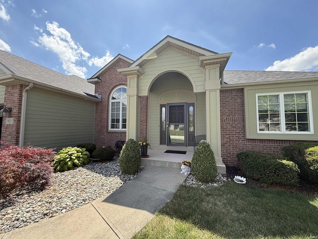 9825 Tamar Trl, Fort Wayne, IN 46825 - property entrance with brick siding and roof with shingles