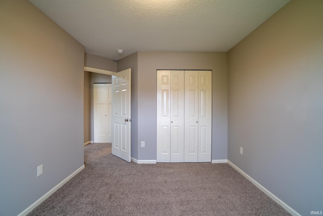 3827 Winter Raven Trl, Fort Wayne, IN 46818 - unfurnished bedroom featuring carpet flooring, a closet, and a textured ceiling