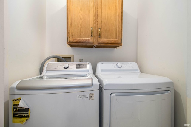1983 Greenock St, South Bend, IN 46614 - laundry area featuring cabinet space and washer and dryer