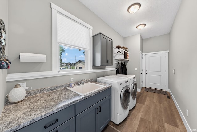 1229 Corby Blvd, South Bend, IN 46617 - laundry room with separate washer and dryer, cabinet space, wood finished floors, and a textured ceiling