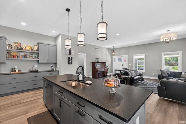 1229 Corby Blvd, South Bend, IN 46617 - kitchen with gray cabinetry, dark countertops, open floor plan, light wood finished floors, and recessed lighting
