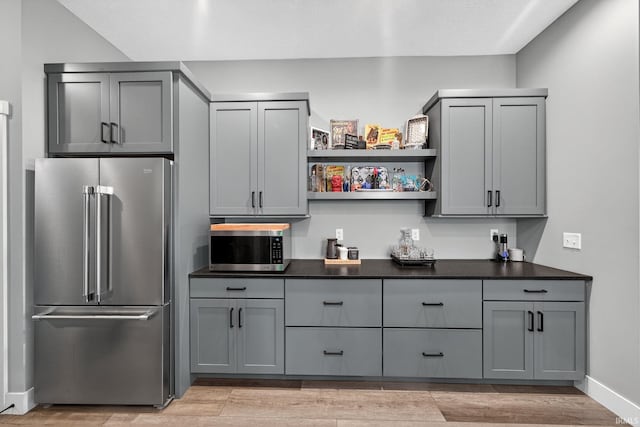 1229 Corby Blvd, South Bend, IN 46617 - kitchen featuring appliances with stainless steel finishes, gray cabinetry, dark countertops, and light wood finished floors