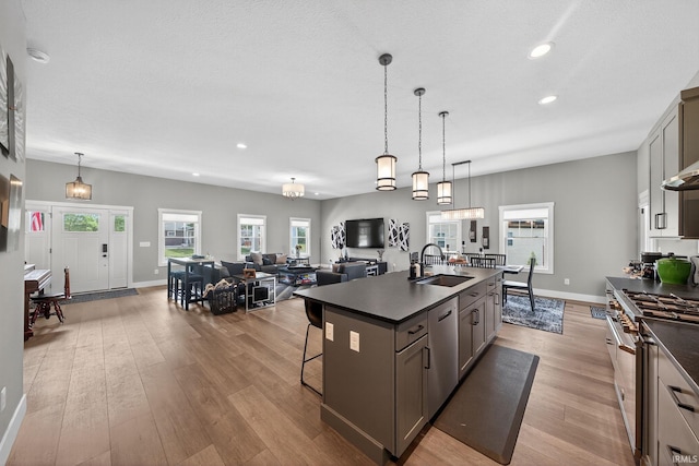 1229 Corby Blvd, South Bend, IN 46617 - kitchen featuring stainless steel appliances, dark countertops, recessed lighting, light wood-type flooring, and a kitchen breakfast bar