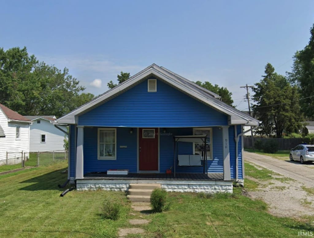 918 E Morgan St, Kokomo, IN 46901 - shotgun-style home with a porch and dirt driveway