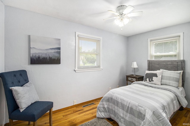 19545 Hildebrand St, South Bend, IN 46614 - bedroom with wood finished floors, multiple windows, and a ceiling fan