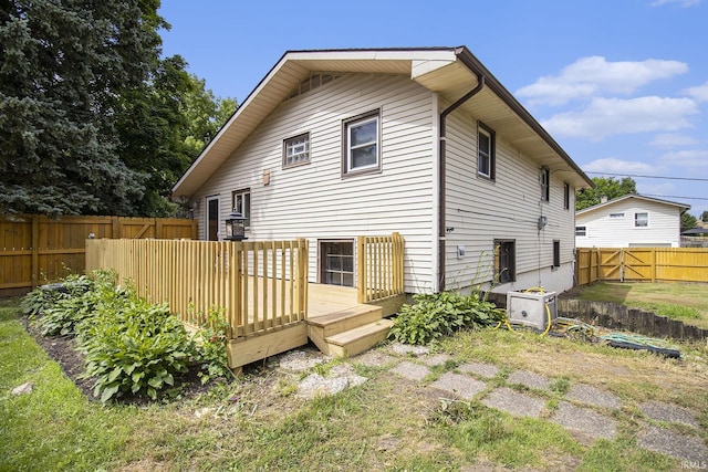 19545 Hildebrand St, South Bend, IN 46614 - back of house featuring a wooden deck and a fenced backyard