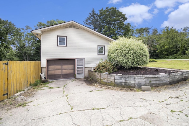 19545 Hildebrand St, South Bend, IN 46614 - view of property exterior featuring an attached garage and driveway