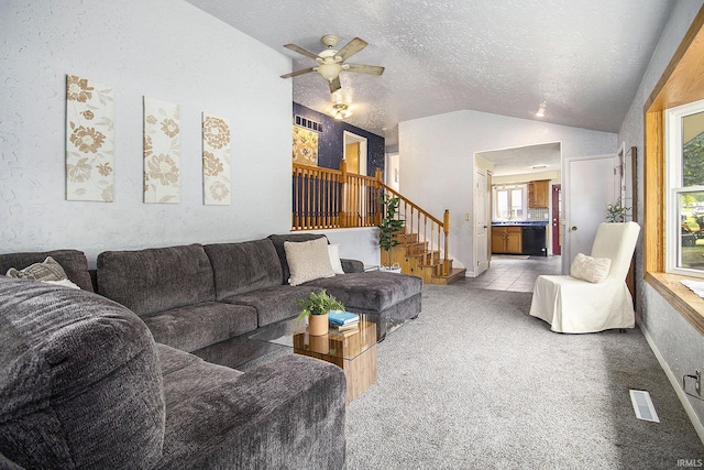 19545 Hildebrand St, South Bend, IN 46614 - living area with vaulted ceiling, a ceiling fan, stairs, and a textured ceiling