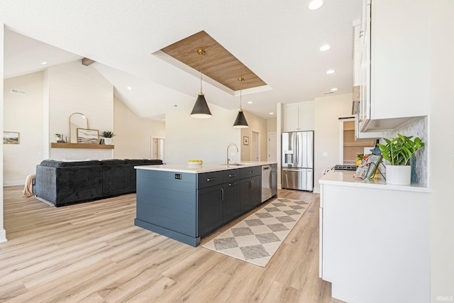 17882 Pavia Pass, Huntertown, IN 46748 - kitchen featuring appliances with stainless steel finishes, white cabinets, light countertops, a kitchen island with sink, and light wood finished floors