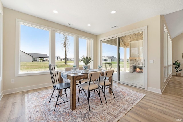 17882 Pavia Pass, Huntertown, IN 46748 - dining area with plenty of natural light, light wood-style floors, a fireplace, and recessed lighting