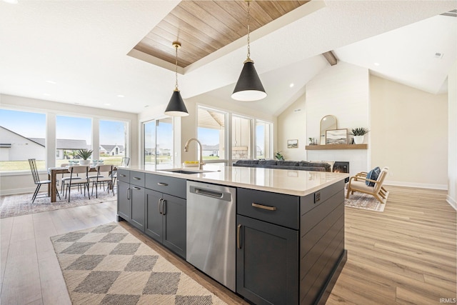 17882 Pavia Pass, Huntertown, IN 46748 - kitchen with stainless steel dishwasher, light countertops, light wood-type flooring, a center island with sink, and hanging light fixtures