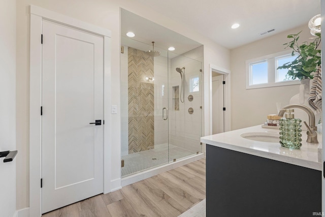 17882 Pavia Pass, Huntertown, IN 46748 - bathroom featuring a shower stall, wood finished floors, vanity, and recessed lighting