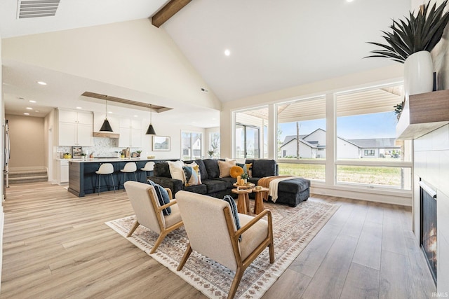 17882 Pavia Pass, Huntertown, IN 46748 - living room featuring high vaulted ceiling, light wood-style floors, beam ceiling, healthy amount of natural light, and recessed lighting