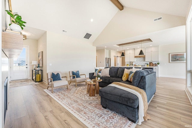 17882 Pavia Pass, Huntertown, IN 46748 - living room featuring high vaulted ceiling, light wood finished floors, and beam ceiling