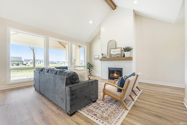 17882 Pavia Pass, Huntertown, IN 46748 - living room with a tile fireplace, beamed ceiling, light wood-style flooring, high vaulted ceiling, and recessed lighting