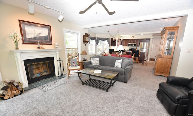 9841 S Harbour Pointe Dr, Bloomington, IN 47401 - living area with ceiling fan, light carpet, and a glass covered fireplace