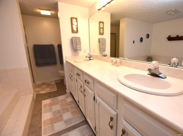 9841 S Harbour Pointe Dr, Bloomington, IN 47401 - full bathroom featuring a textured ceiling, double vanity, a tub to relax in, an enclosed shower, and tile patterned floors