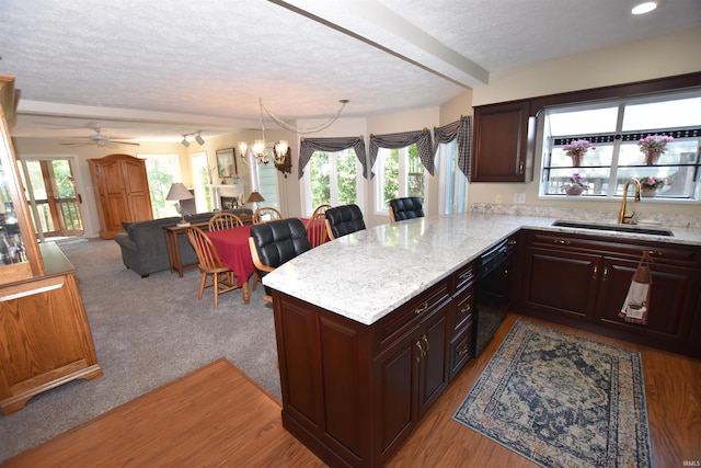 9841 S Harbour Pointe Dr, Bloomington, IN 47401 - kitchen with black dishwasher, a textured ceiling, healthy amount of natural light, a chandelier, and beam ceiling