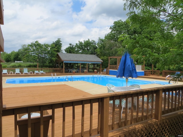 9841 S Harbour Pointe Dr, Bloomington, IN 47401 - community pool with a gazebo, a wooden deck, and view of wooded area