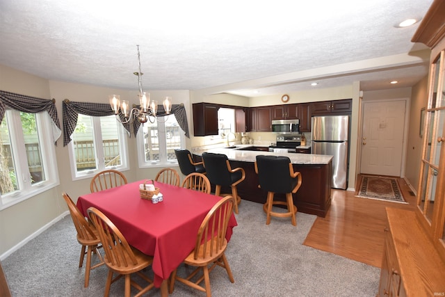 9841 S Harbour Pointe Dr, Bloomington, IN 47401 - dining area with a textured ceiling, a chandelier, recessed lighting, and light carpet