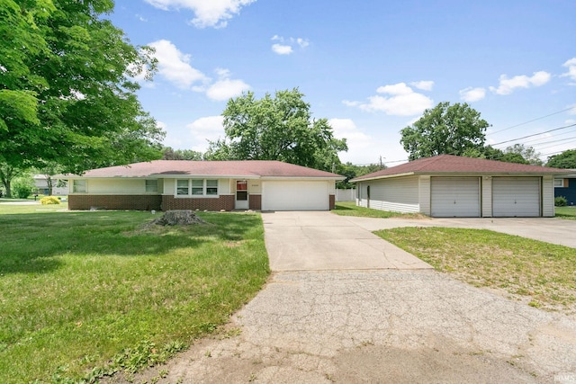 23099 Gardena Pl, Elkhart, IN 46514 - single story home with a front yard, a garage, brick siding, and an outbuilding