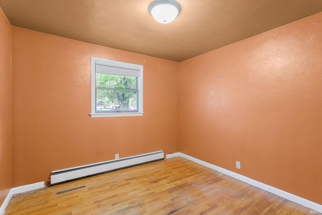 23099 Gardena Pl, Elkhart, IN 46514 - unfurnished room with baseboard heating and wood finished floors