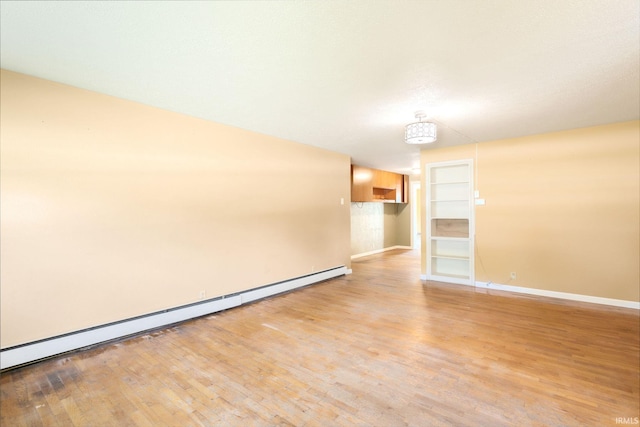 23099 Gardena Pl, Elkhart, IN 46514 - spare room with light wood-style floors and baseboard heating