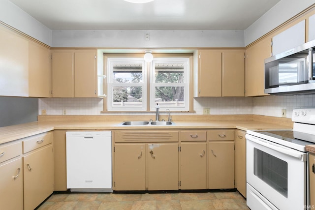 23099 Gardena Pl, Elkhart, IN 46514 - kitchen with white appliances, light countertops, backsplash, and cream cabinets