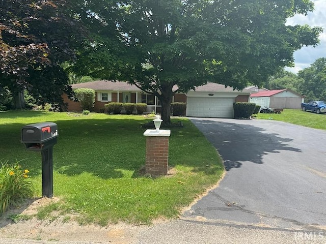 803 Stanley St, Logansport, IN 46947 - ranch-style house with asphalt driveway, a front yard, and a garage